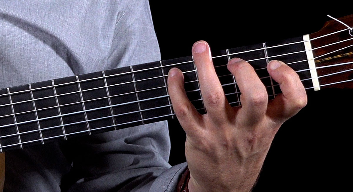 Adam del Monte demonstrating a right hand practice routine on the guitar fretboard. The Art of Playing Slowly: A Guide for Classical and Flamenco Guitarists